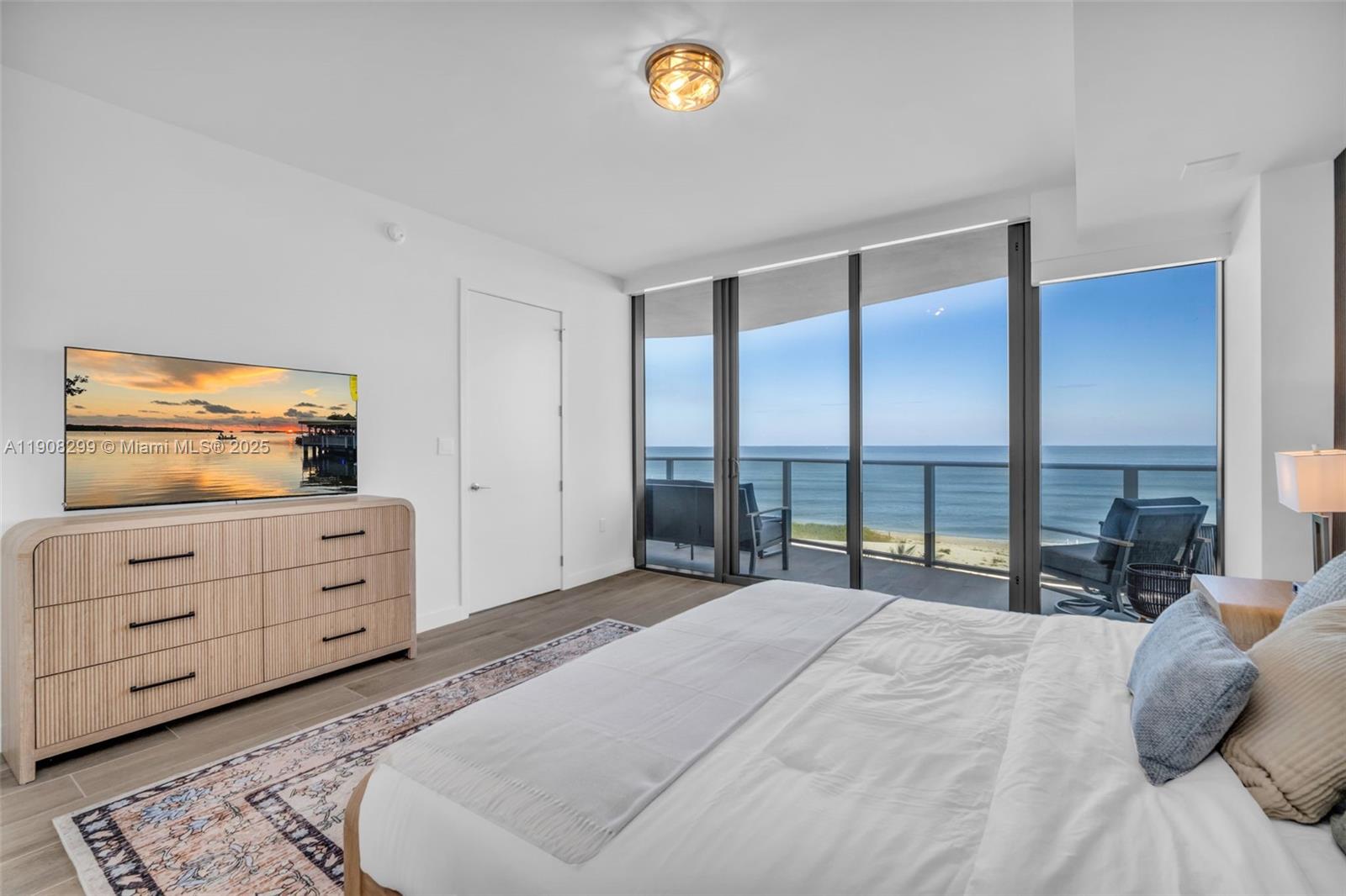 900 North Ocean Boulevard, Unit 503 Pompano Beach, FL 33062 - Photo 40 of 99 a bedroom with a bed and a dresser