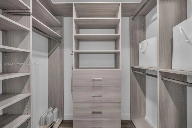 a living room with furniture a window and a flat screen tv