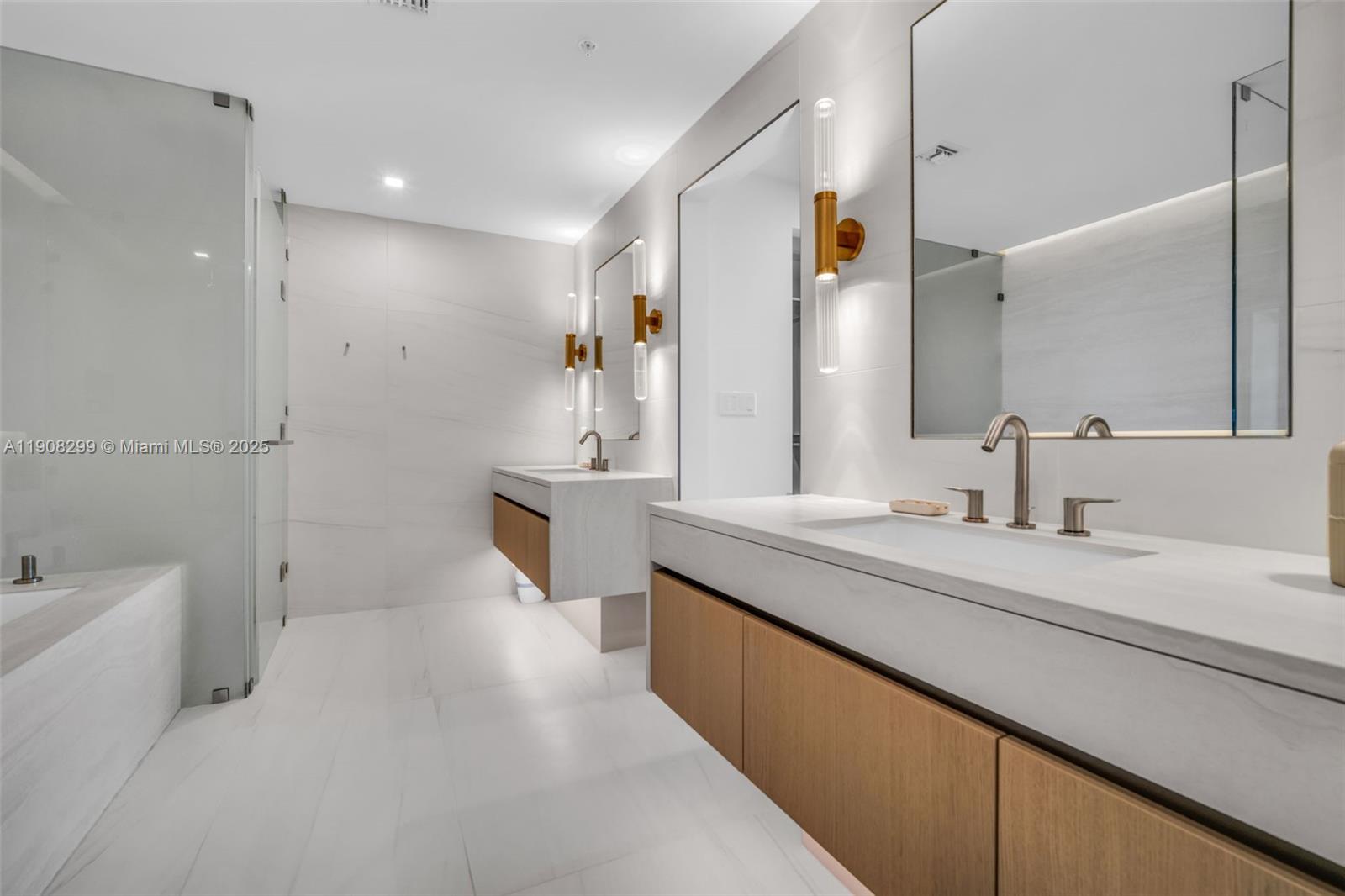 900 North Ocean Boulevard, Unit 503 Pompano Beach, FL 33062 - Photo 45 of 99 a spacious bathroom with a sink a mirror a bathtub and shower