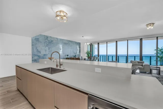 a dining room with furniture a chandelier and wooden floor
