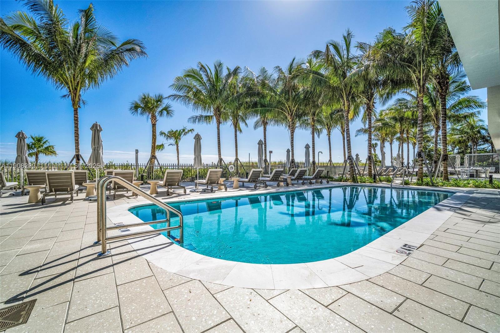 900 North Ocean Boulevard, Unit 503 Pompano Beach, FL 33062 - Photo 94 of 99 a view of swimming pool with outdoor seating and palm tree
