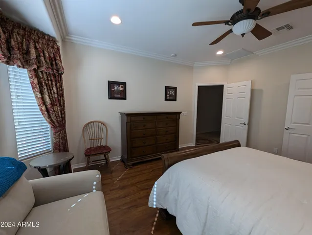 a bedroom with double bed and a dresser