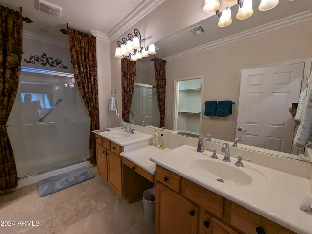 a bathroom with a sink and mirror with toilet