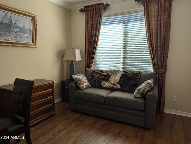 a bedroom with furniture and a flat screen tv