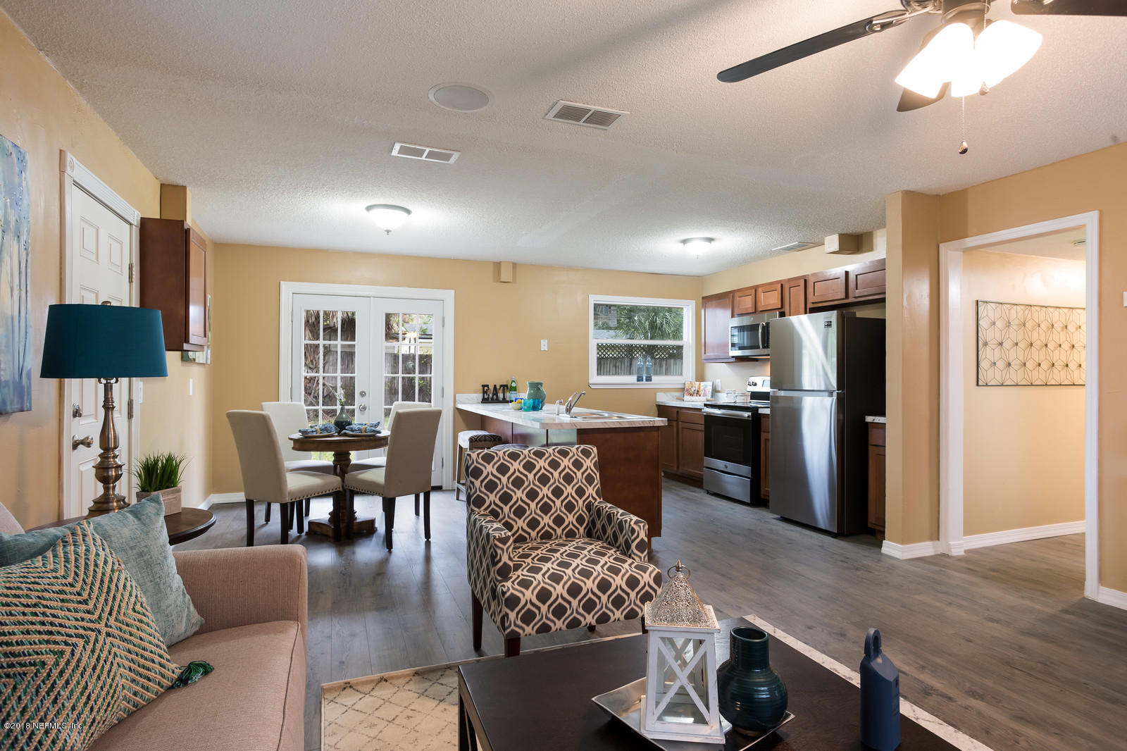 317 Sargo Road Atlantic Beach, FL 32233 - Photo 7 of 17 a living room with furniture wooden floor and a view of kitchen