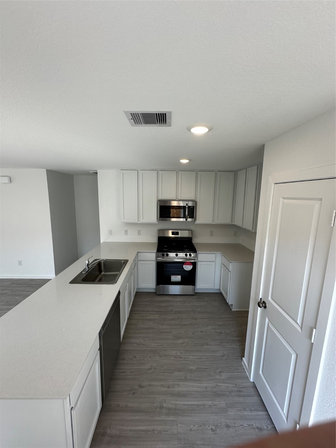 6007 Patriot Sound Road Humble, TX 77338 - Photo 6 of 34 a kitchen with stainless steel appliances a refrigerator and a stove top oven