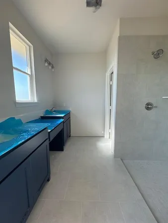 a kitchen with stainless steel appliances granite countertop a sink and white cabinets with granite countertops