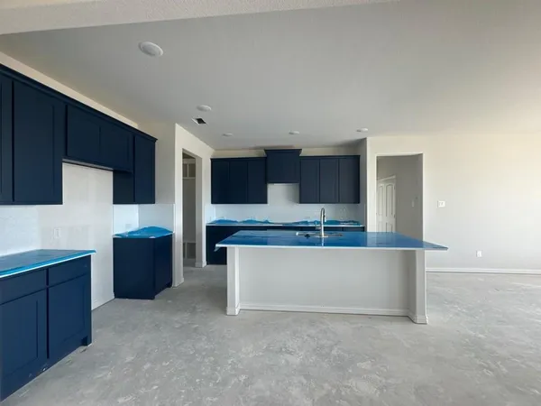 a living room with stainless steel appliances kitchen island a cabinets and wooden floor