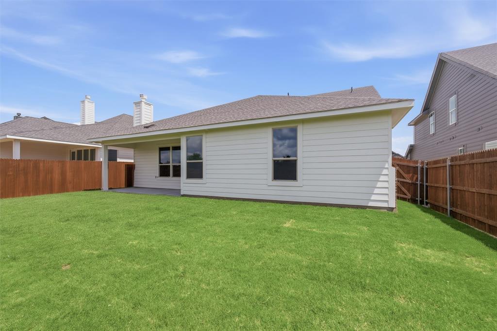 1232 Colca Drive Springtown, TX 76082 - Photo 22 of 23 Spacious backyard featuring a manicured lawn, a covered patio, and a privacy fence