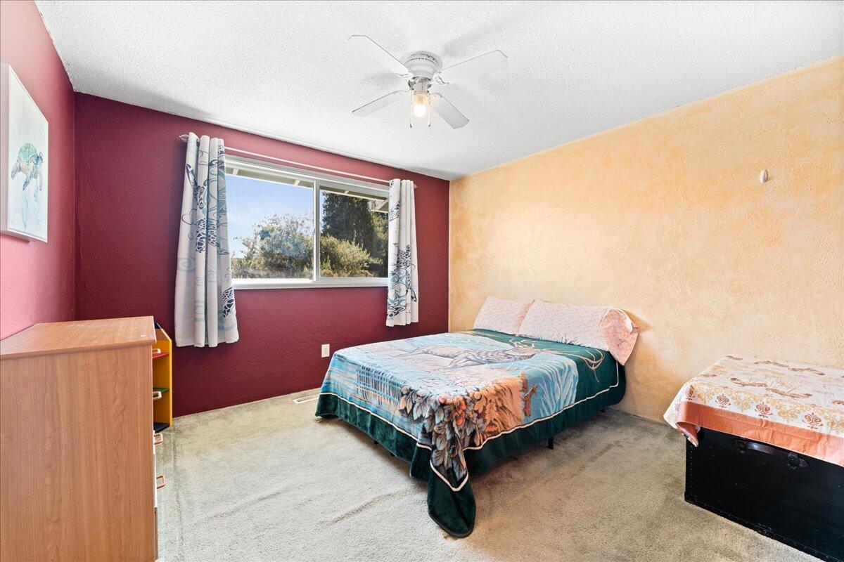 4093 Old Upton Road Central Point, OR 97502 - Photo 16 of 23 a bedroom with a bed and a chandelier