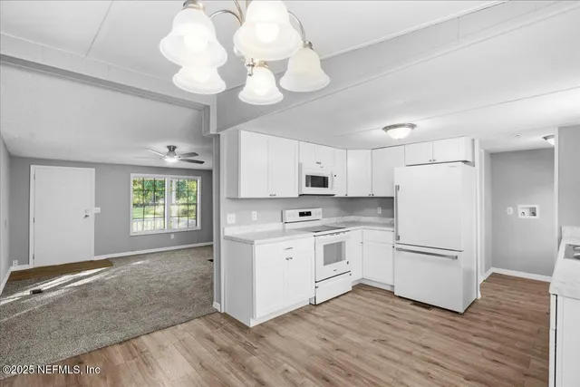 a kitchen with white cabinets stainless steel appliances and sink