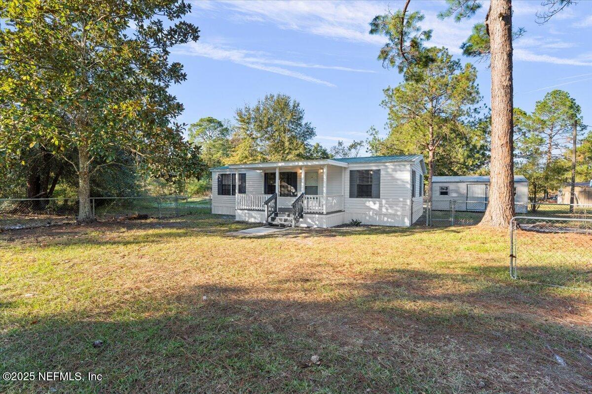 6480 Keith Griffis Circle Macclenny, FL 32063 - Photo 2 of 50 a front view of house with yard and swimming pool