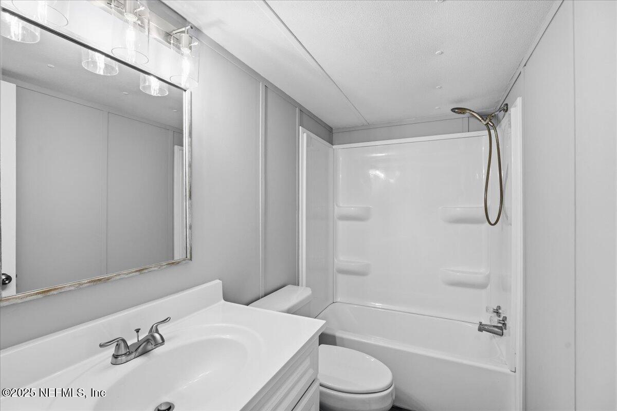 6480 Keith Griffis Circle Macclenny, FL 32063 - Photo 22 of 50 a bathroom with a sink toilet and shower
