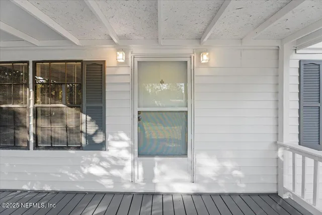 an empty room with fan and windows