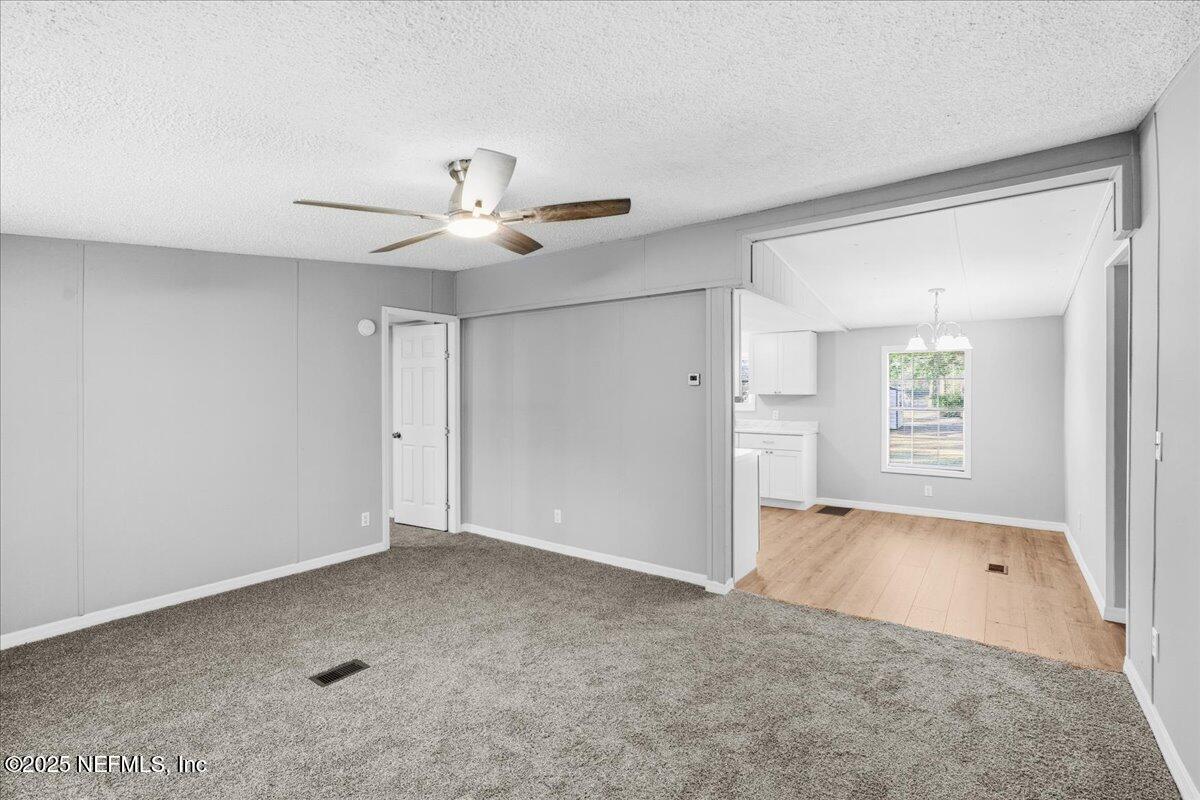 6480 Keith Griffis Circle Macclenny, FL 32063 - Photo 8 of 50 an empty room with fan and windows
