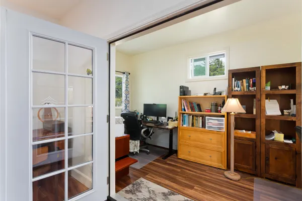 a living room with furniture a flat screen tv and a window