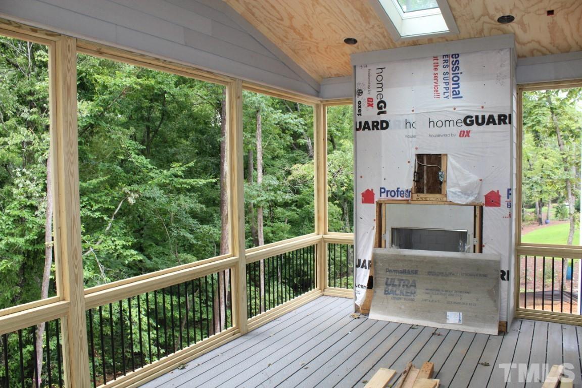 2309 Sanctuary Drive Raleigh, NC 27606 - Photo 11 of 22 a balcony with table and chairs and wooden floor