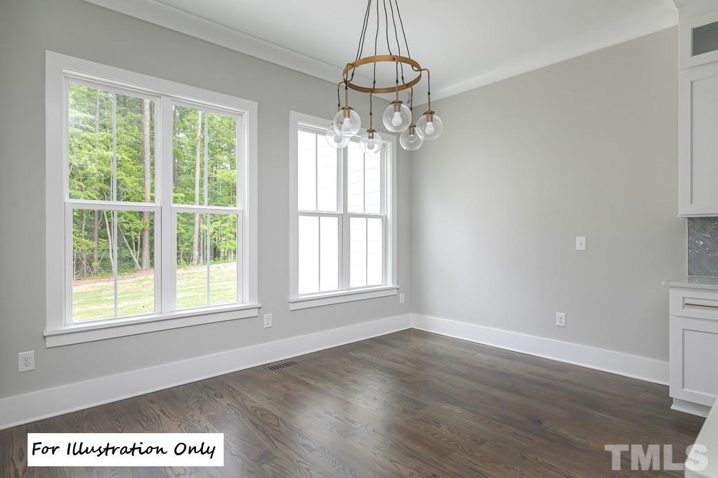 2309 Sanctuary Drive Raleigh, NC 27606 - Photo 13 of 22 a view of an empty room with wooden floor and a window