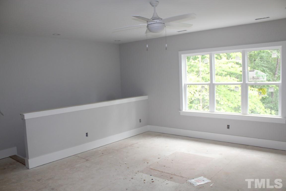 2309 Sanctuary Drive Raleigh, NC 27606 - Photo 16 of 22 an empty room with a window and ceiling fan