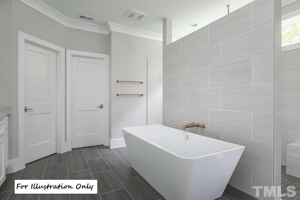 2309 Sanctuary Drive Raleigh, NC 27606 - Photo 17 of 22 a white bath tub sitting in a bathroom