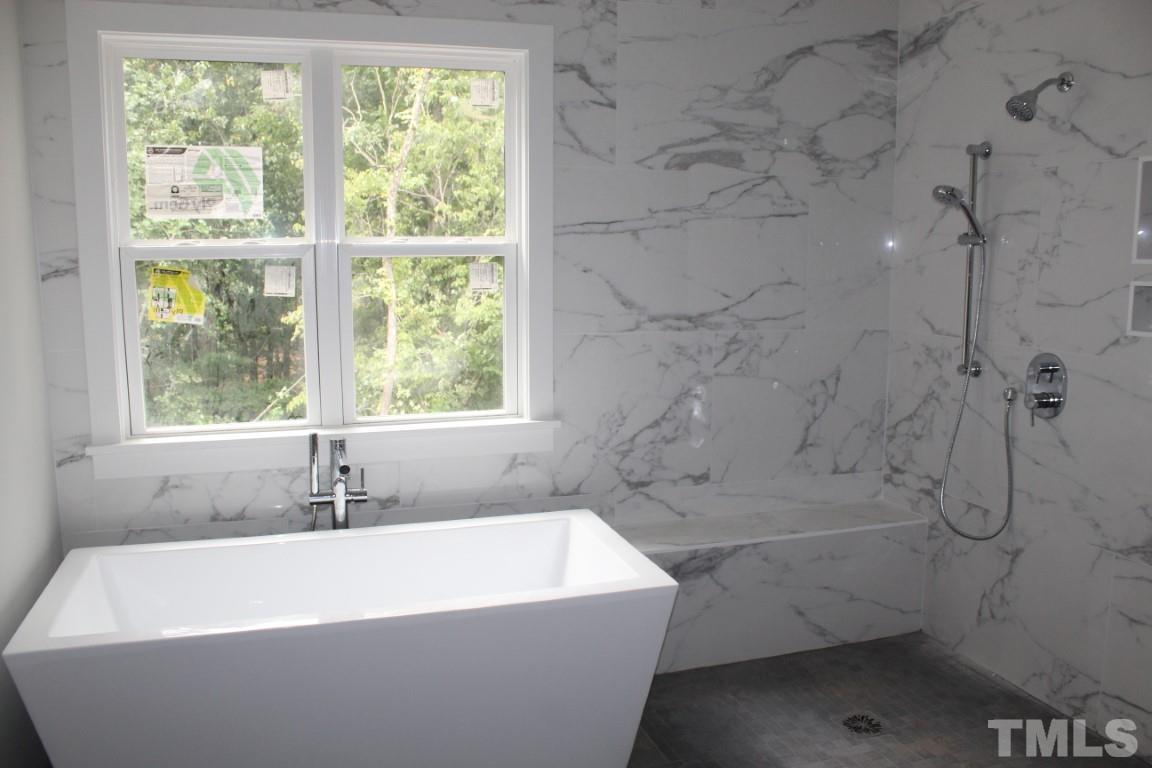 2309 Sanctuary Drive Raleigh, NC 27606 - Photo 9 of 22 a white bath tub sitting next to a shower