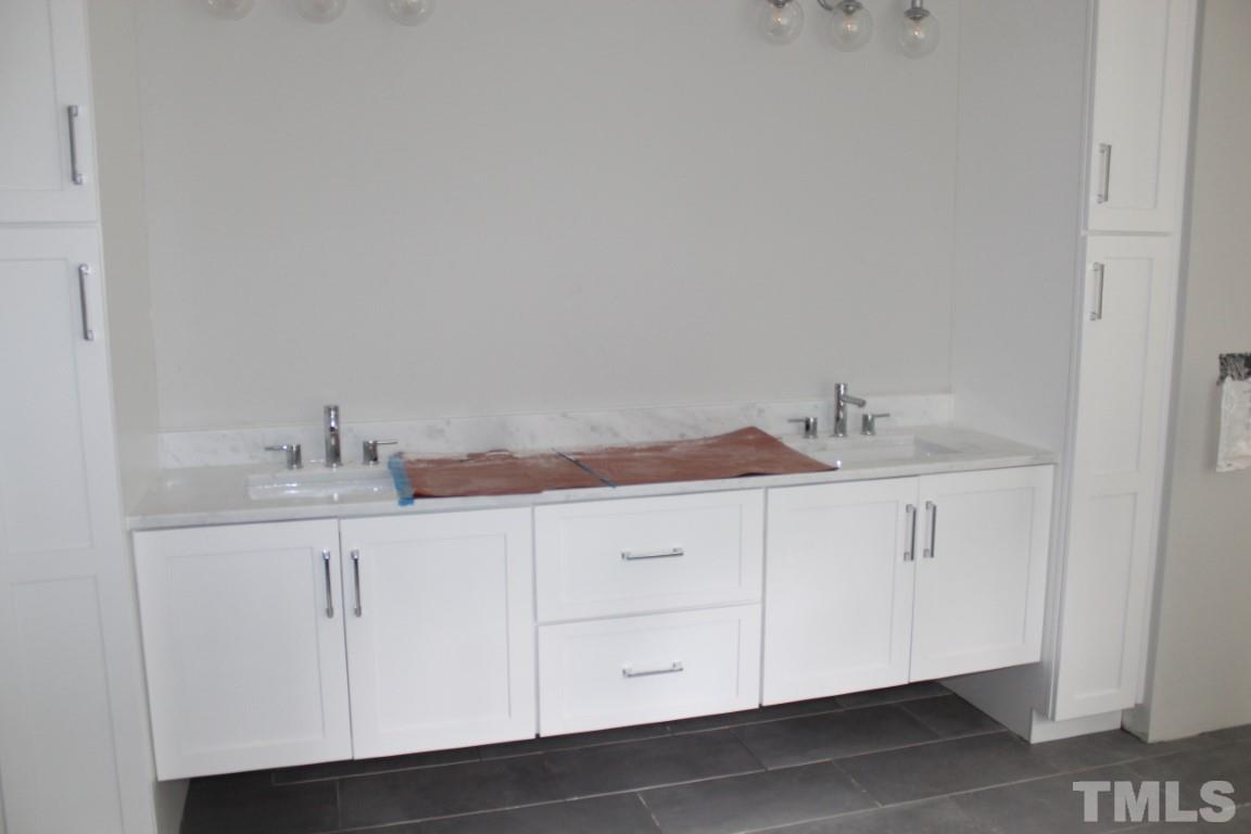 2309 Sanctuary Drive Raleigh, NC 27606 - Photo 10 of 22 a bathroom with a sink and cabinets
