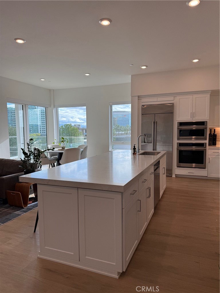 3414 Rivington Irvine, CA 92612 - Photo 11 of 33 a large kitchen with stainless steel appliances a large counter top a stove and a sink