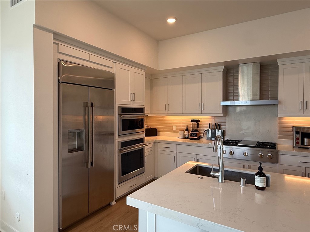3414 Rivington Irvine, CA 92612 - Photo 13 of 33 a kitchen with a refrigerator a stove and a sink