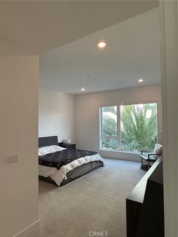 a living room with furniture and a floor to ceiling window