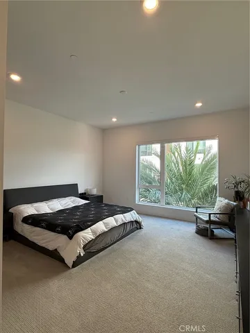 a bed sitting in a room next to a window