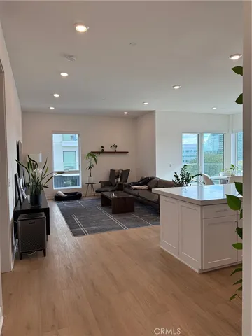 a kitchen with sink and living room