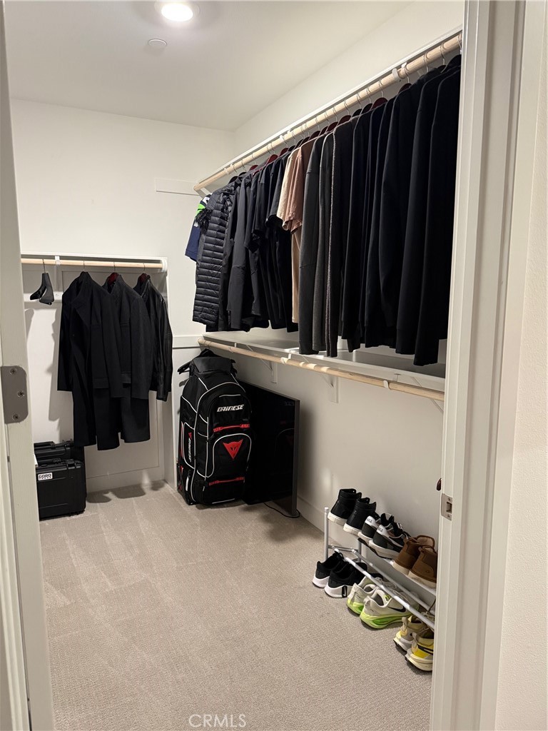 3414 Rivington Irvine, CA 92612 - Photo 23 of 33 a view of walk in closet with clothes and shoes