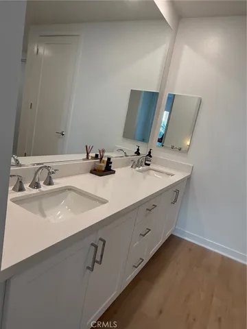 a bathroom with a double vanity sink and mirror