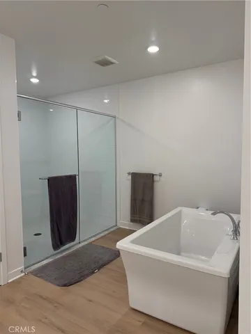 a bathroom with a bathtub and shower