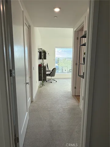 a living room with furniture and a walk in closet
