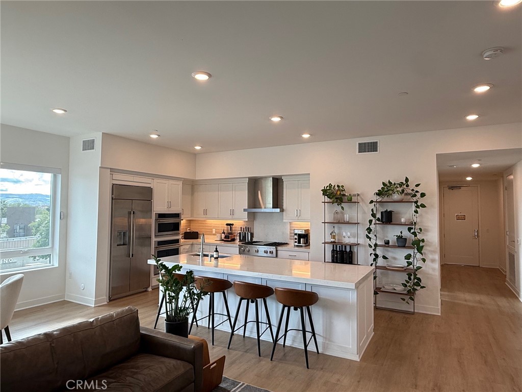 3414 Rivington Irvine, CA 92612 - Photo 6 of 33 a kitchen with a dining table chairs and refrigerator
