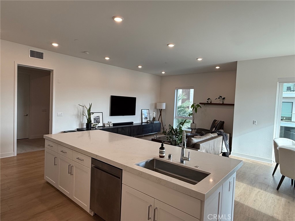 3414 Rivington Irvine, CA 92612 - Photo 10 of 33 a kitchen with a sink and a refrigerator