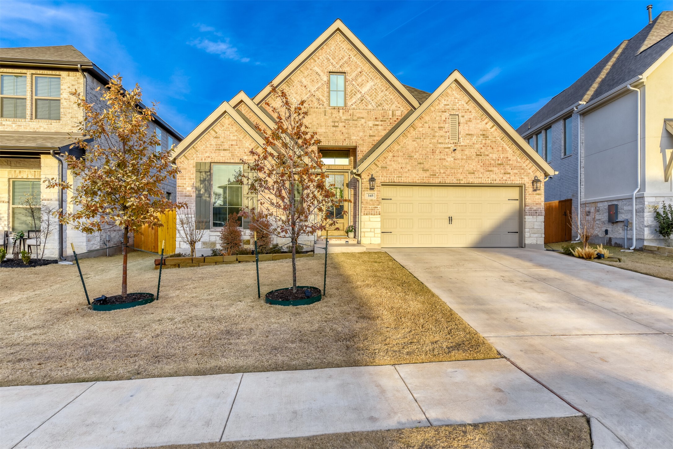 345 Prickly Poppy Loop Kyle, TX 78640 - Photo 1 of 1 Traditional-style house featuring brick siding, concrete driveway, and a garage