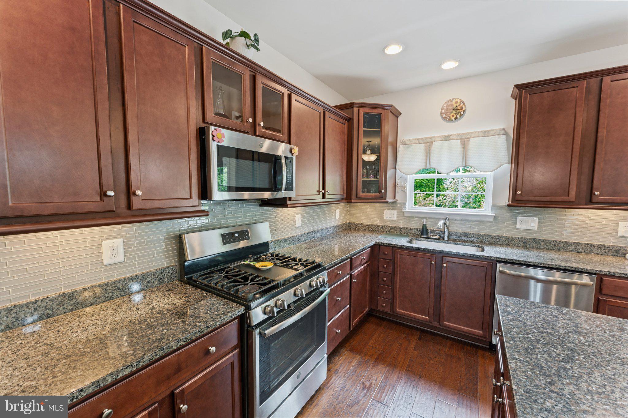 320 Tree Line Drive Fredericksburg, VA 22405 - Photo 16 of 49 a kitchen with stainless steel appliances granite countertop a stove a sink and a microwave
