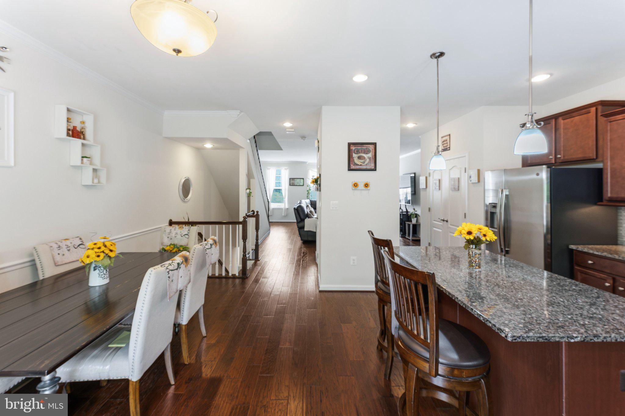 320 Tree Line Drive Fredericksburg, VA 22405 - Photo 20 of 49 a kitchen with stainless steel appliances granite countertop a table chairs refrigerator and sink