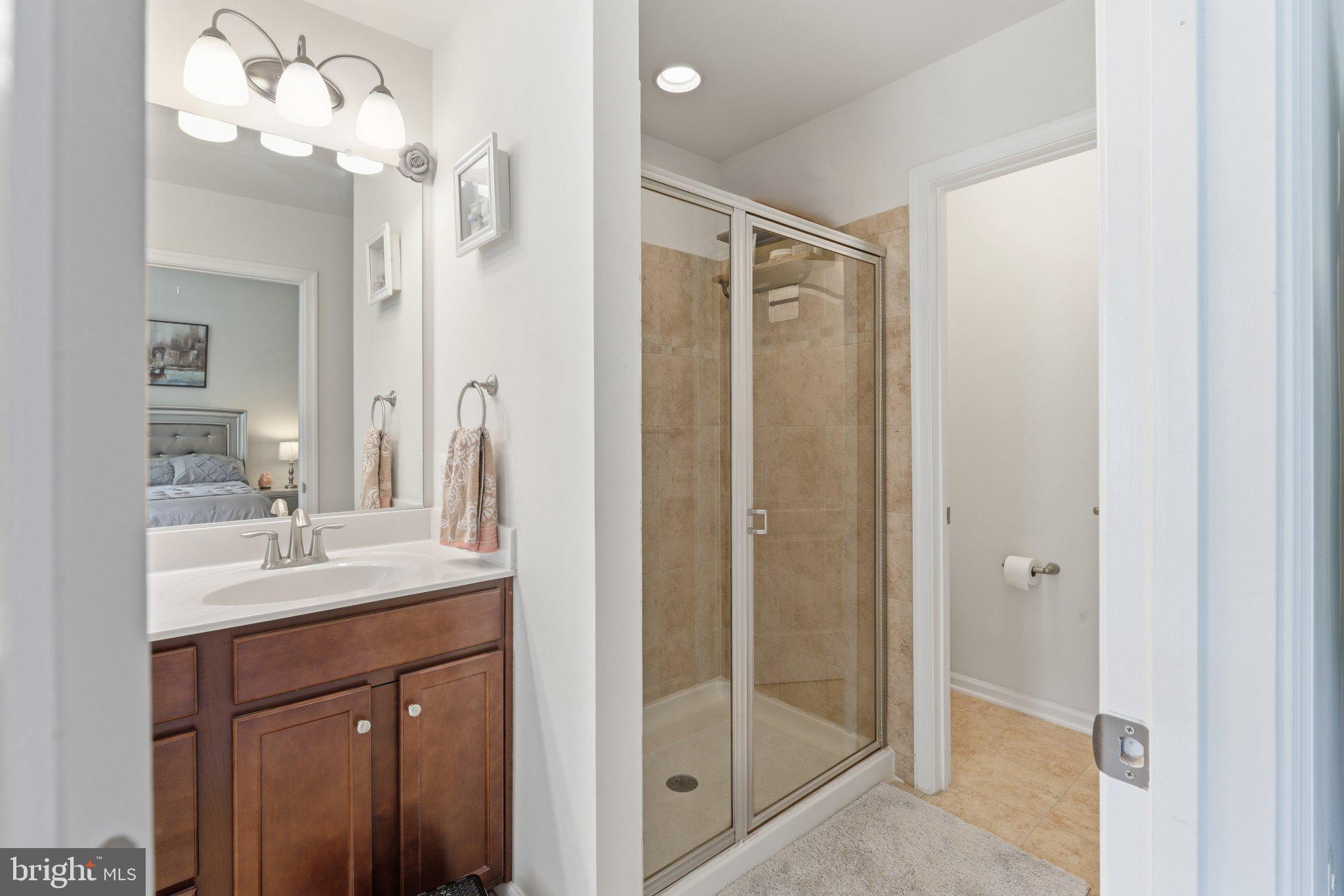 320 Tree Line Drive Fredericksburg, VA 22405 - Photo 33 of 49 a bathroom with a shower sink and mirror