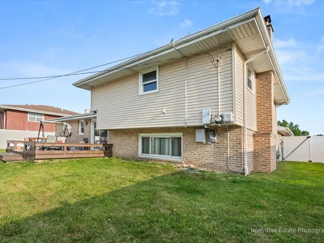 a view of a house with a yard and sitting area