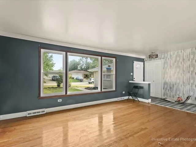 a view of an empty room with a fireplace and a window