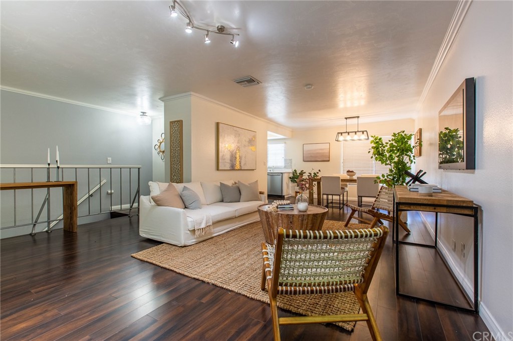a living room with fireplace furniture and a wooden floor
