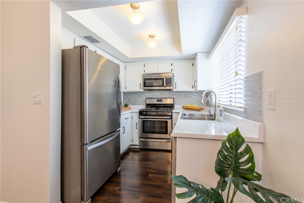 1881 Alpha Road, Unit 5 Glendale, CA 91208 - Photo 9 of 29 a kitchen with stainless steel appliances a refrigerator and a stove top oven