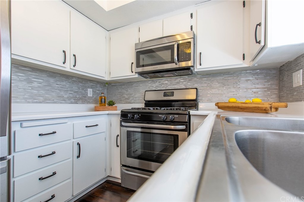 1881 Alpha Road, Unit 5 Glendale, CA 91208 - Photo 10 of 29 a kitchen with stainless steel appliances granite countertop a stove microwave and cabinets