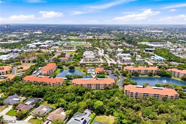 an aerial view of residential houses with city view