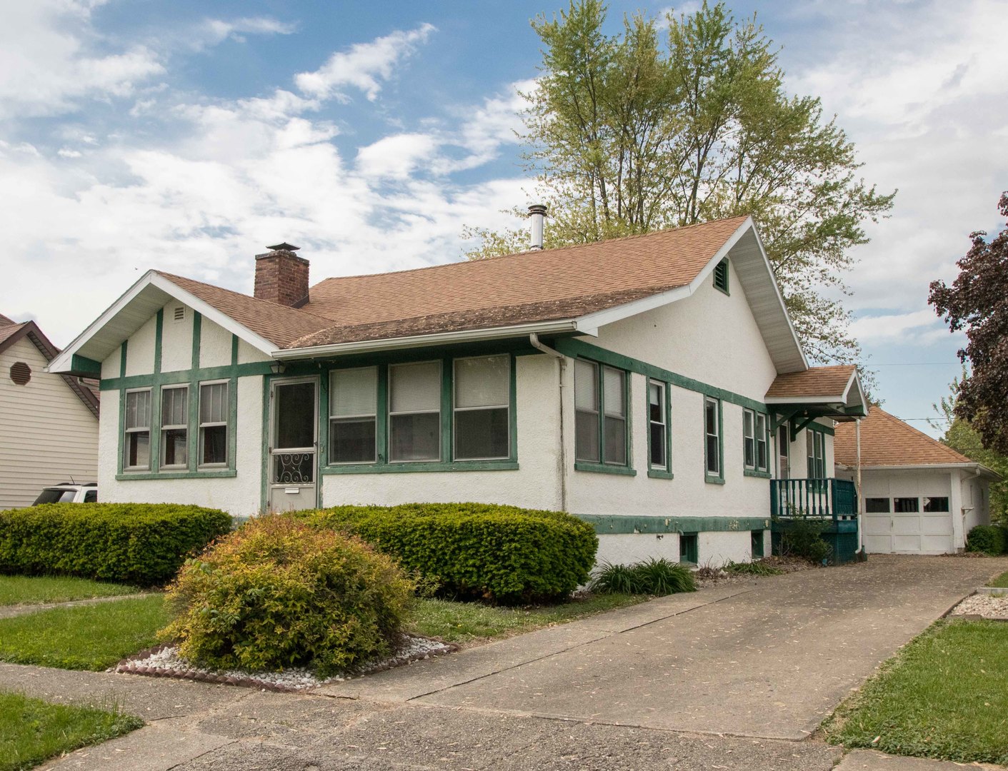 215 Clark Street Georgetown, IL 61846 - Photo 1 of 24 a front view of a house with a garden