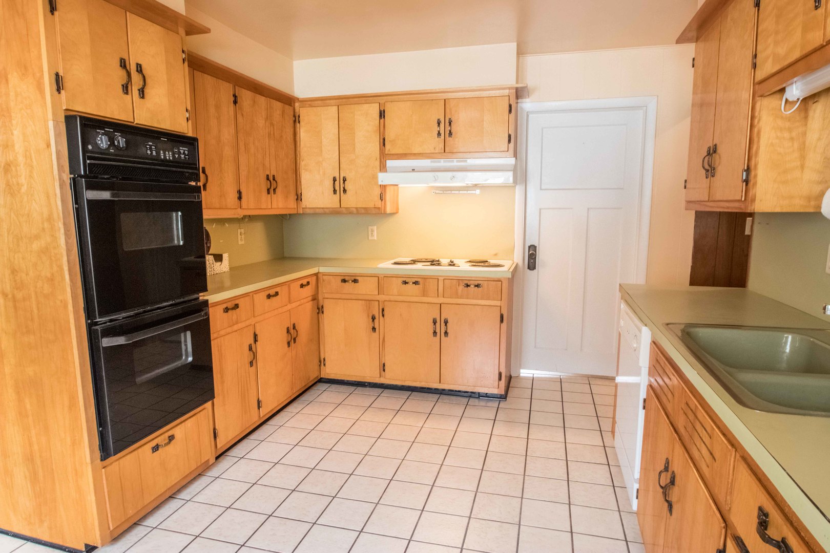215 Clark Street Georgetown, IL 61846 - Photo 7 of 24 a kitchen with a sink stove and refrigerator