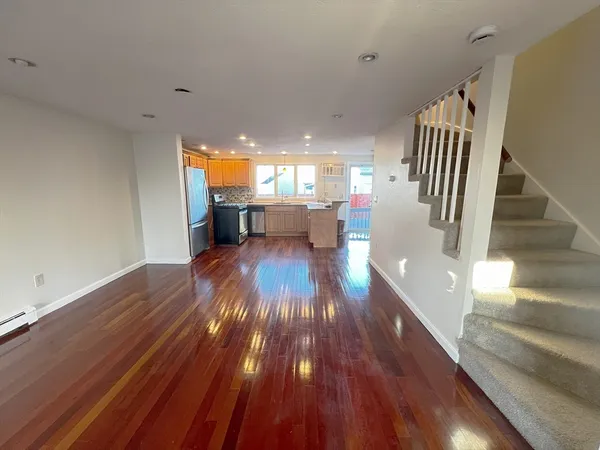 a kitchen with stainless steel appliances granite countertop a sink a stove top oven a counter space and cabinets